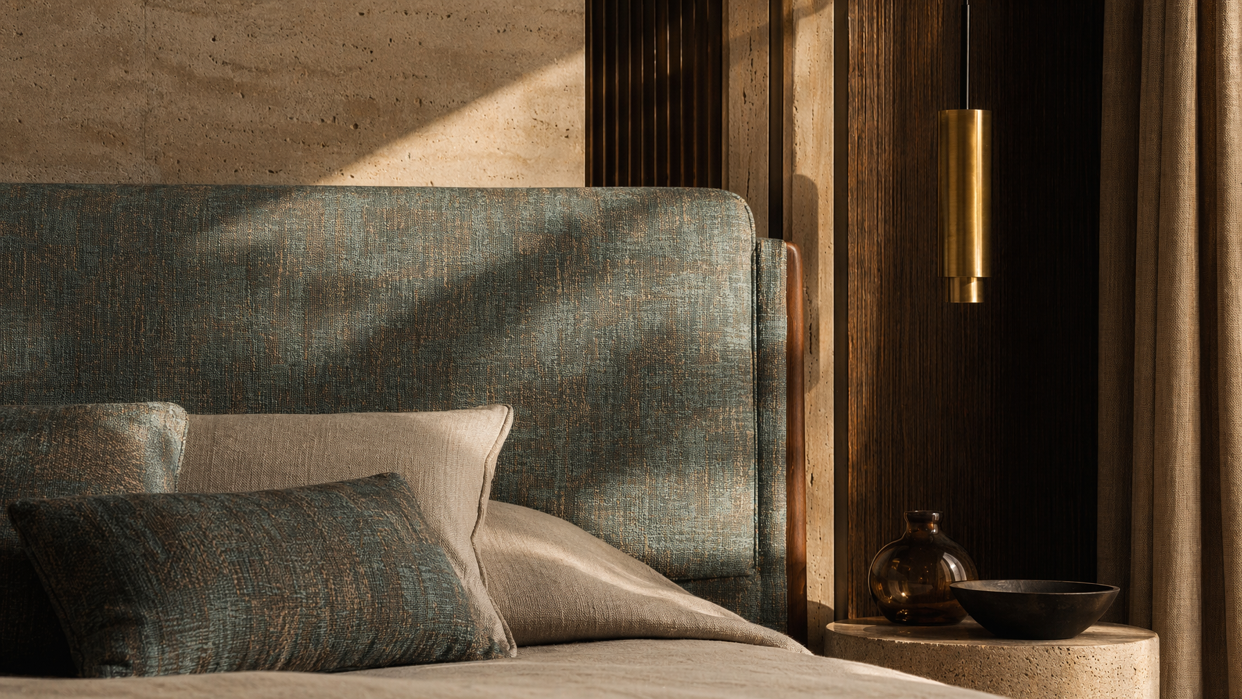 Bed headboard with woven teal and bronze upholstery and layered neutral cushions - Beautiful Homes