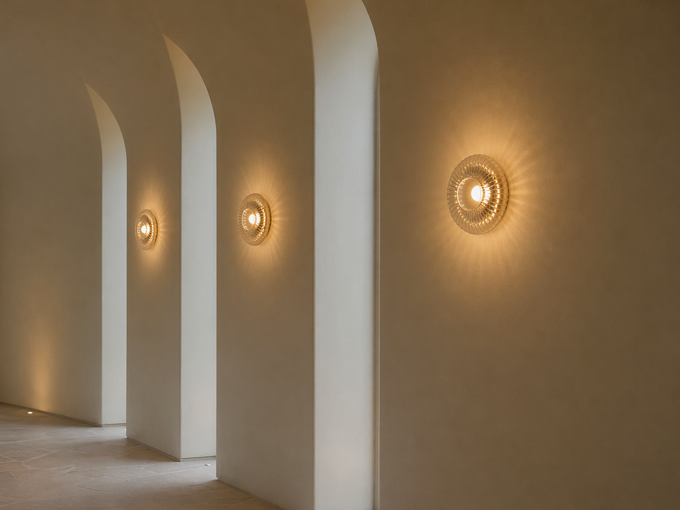 Illuminated wall light with a circular ribbed glass design mounted on a textured arched hallway - Beautiful Homes