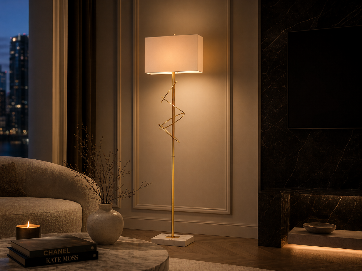 Tall brass floor lamp with a cream fabric shade and sculptural spiral detailing, styled beside a marble coffee table in a luxurious living room setting - Beautiful Homes