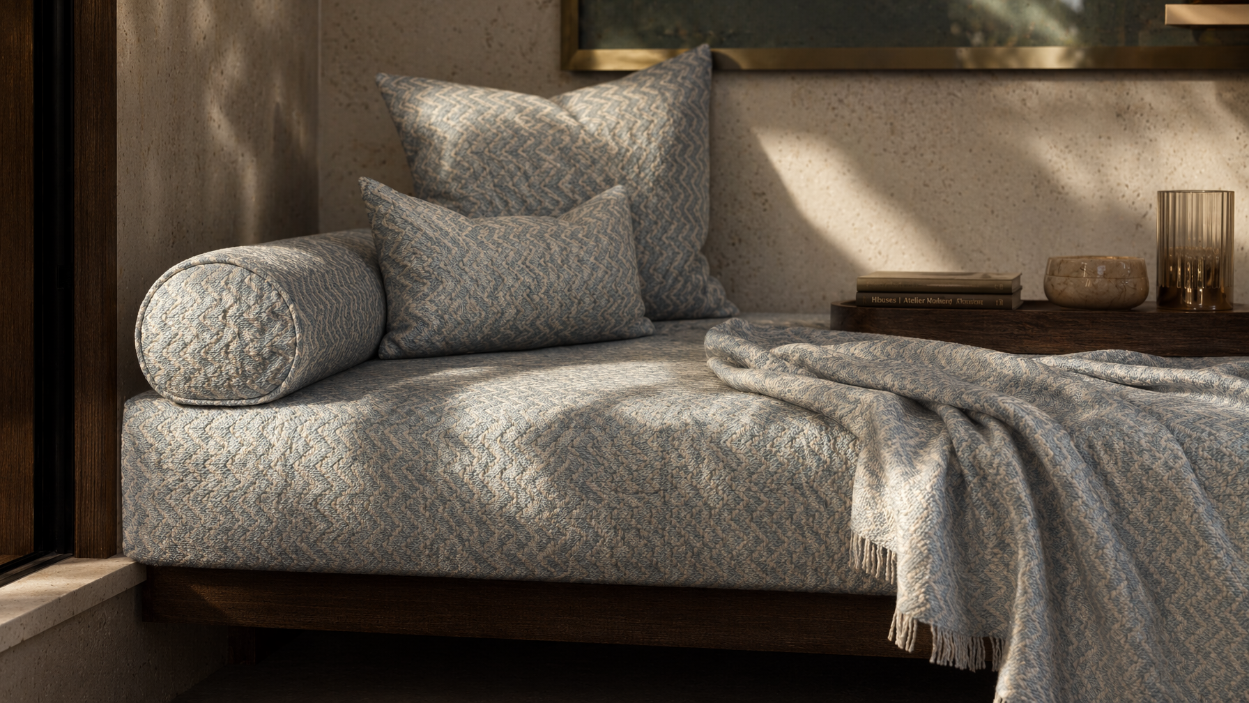 Low-profile sofa furnishing with blue and cream zigzag upholstery, matching bolster and accent cushions - Beautiful Homes