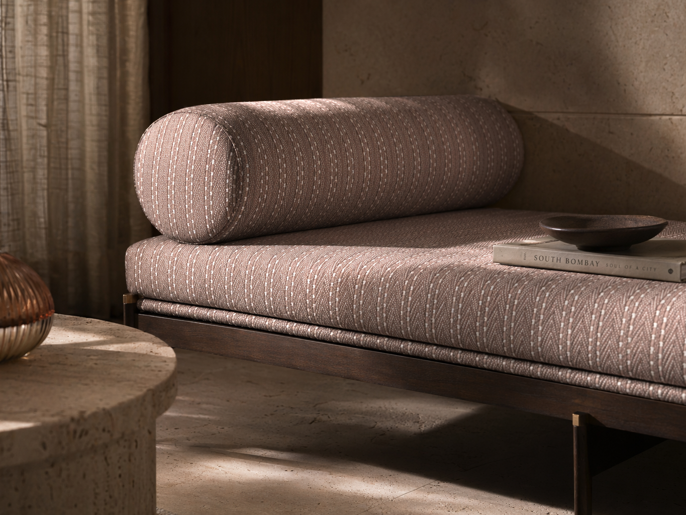 Dark wood daybed with dusty pink patterned upholstery and matching bolster cushion - Beautiful Homes