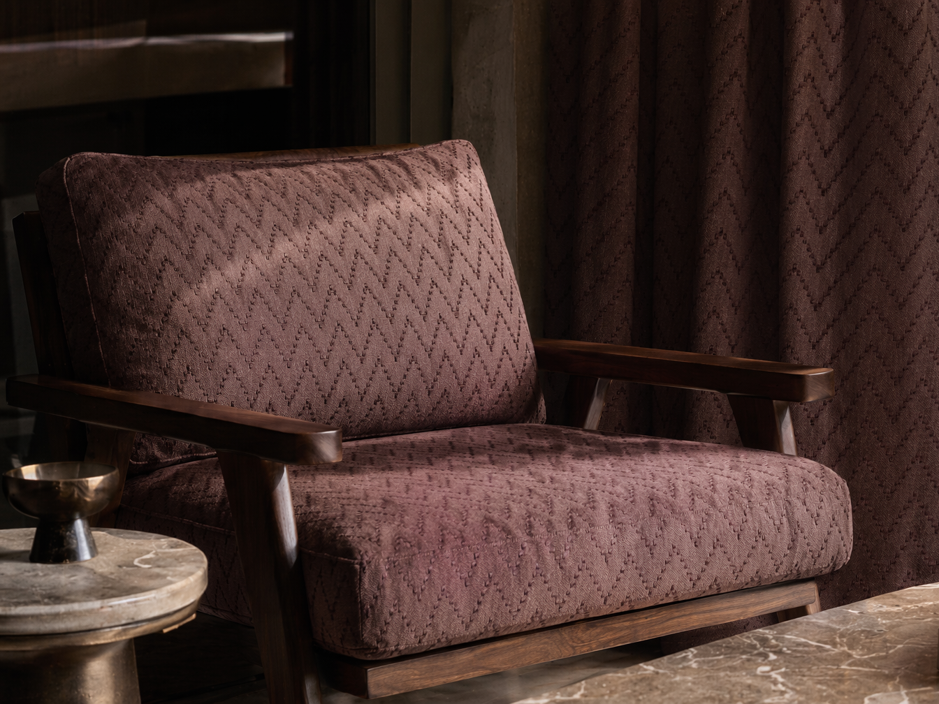 Mid-century style armchair with a dark wood frame and deep plum patterned upholstery - Beautiful Homes