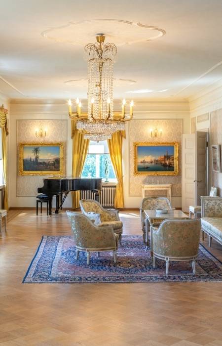 Large chandelier at the center of the room & wall sconces for lighting - Beautiful Homes