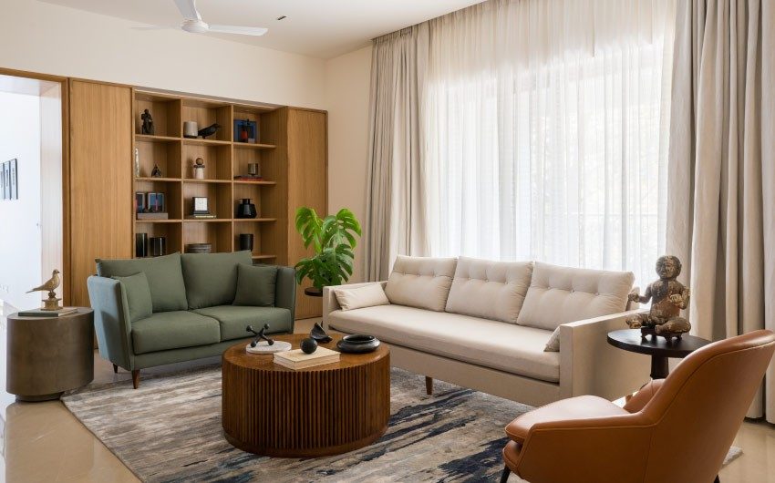 Ceiling-to-floor curtains & sage green two-seater chair for your living room - Beautiful Homes