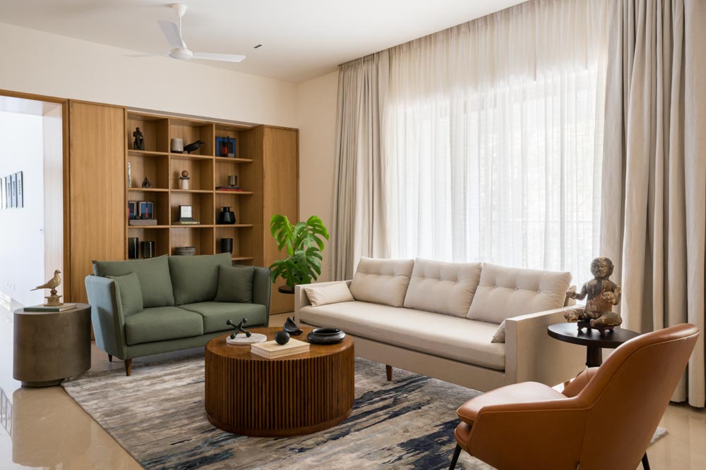 Ceiling-to-floor curtains & sage green two-seater chair for your living room - Beautiful Homes