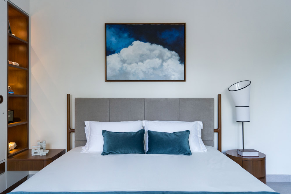 Slender open shelves beside the bed with blue & white colour palette for son's bedroom - Beautiful Homes