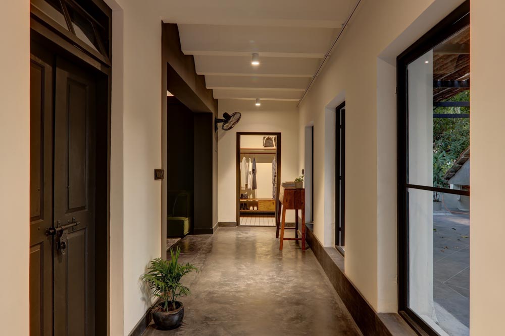 A dressing room at the end of a passage with windows on one side of the passage - Beautiful Homes