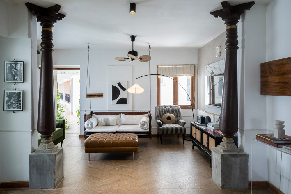 Living room design with wall light on the right is made of clay & other home décor elements - Beautiful Homes
