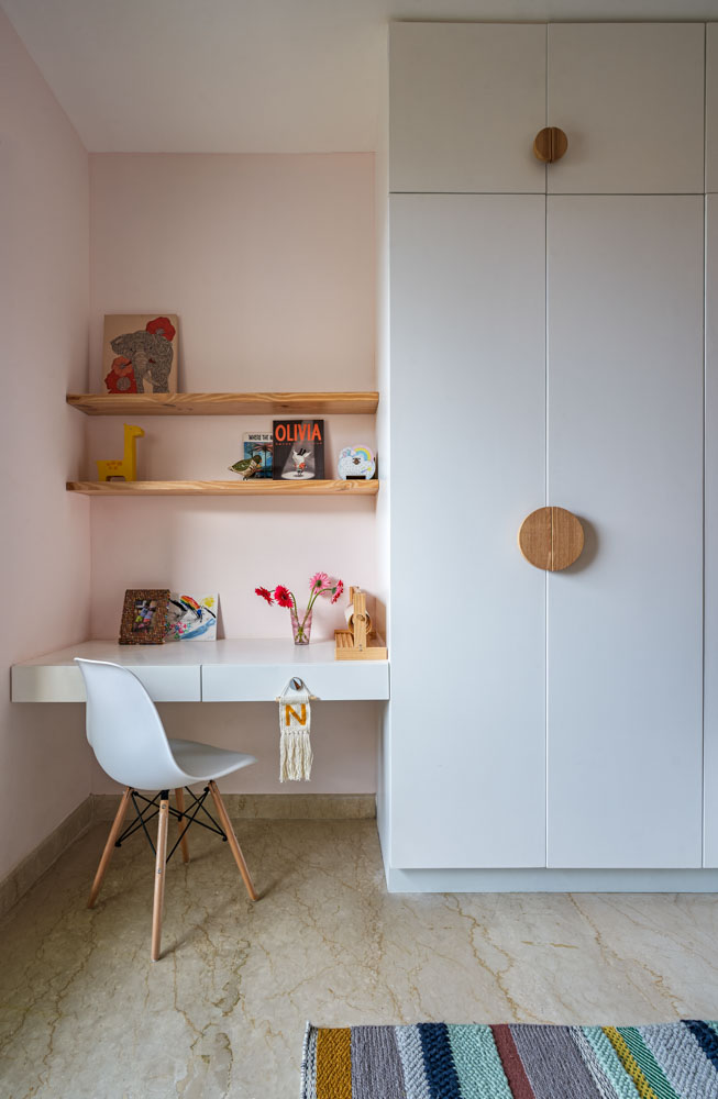 A kids room with a study table in a corner and next to it is a wardrobe - Beautiful Homes