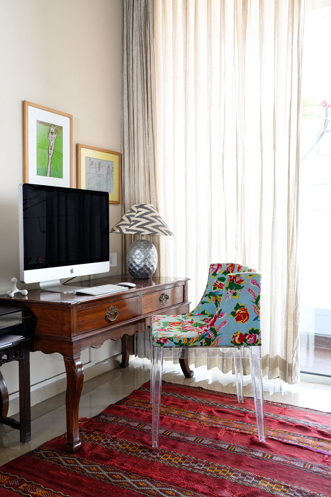 The study in the corner of the living room has drawings made by Pavitra's kids along with a Kartell chair - Beautiful Homes