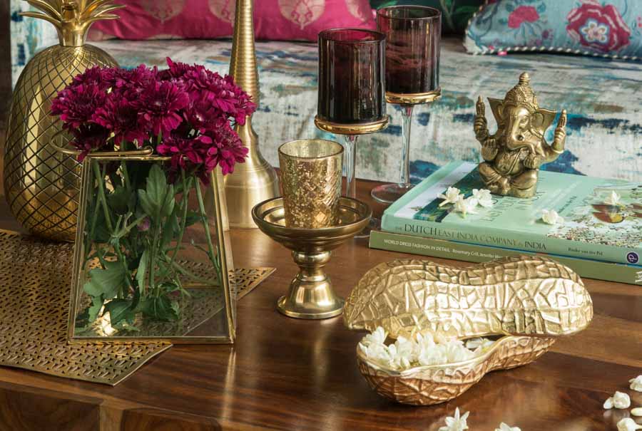 A table with flowers and gold accessories - Beautiful Homes