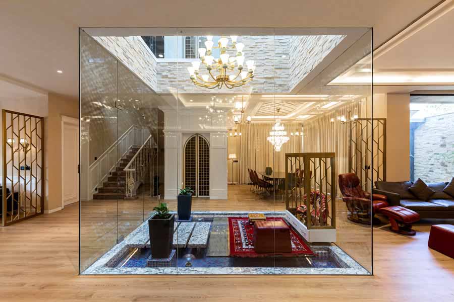 Pooja Room Design at the Centre Part of Living Room With Four Glass Walls - Beautiful Homes