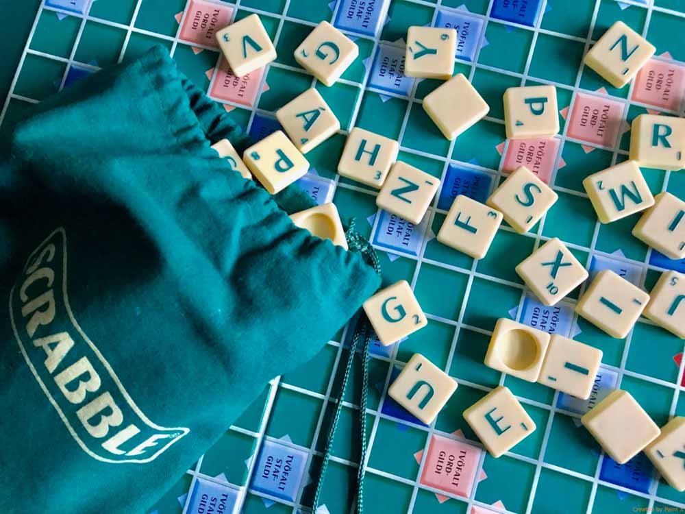 Some scrabble alphabets spread out on a board