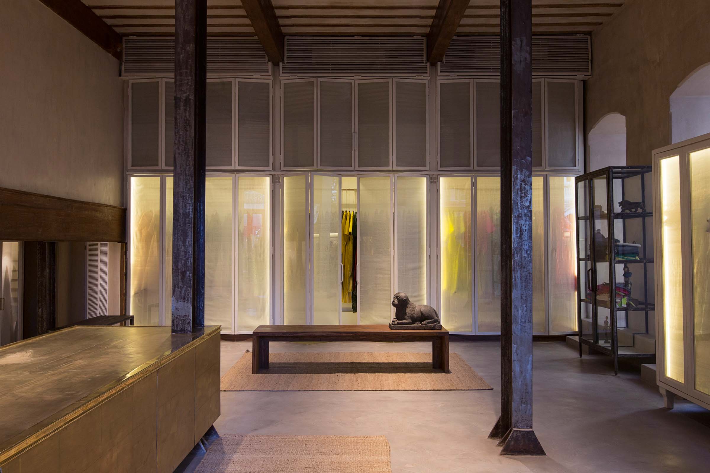 a brass countertop and glass cabinets at Raw Mango’s Mumbai store